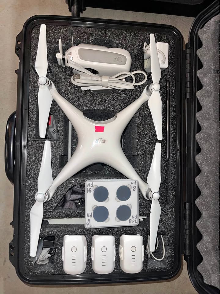 DJI Phantom 4 Pro with rolling hard case and accessories.
